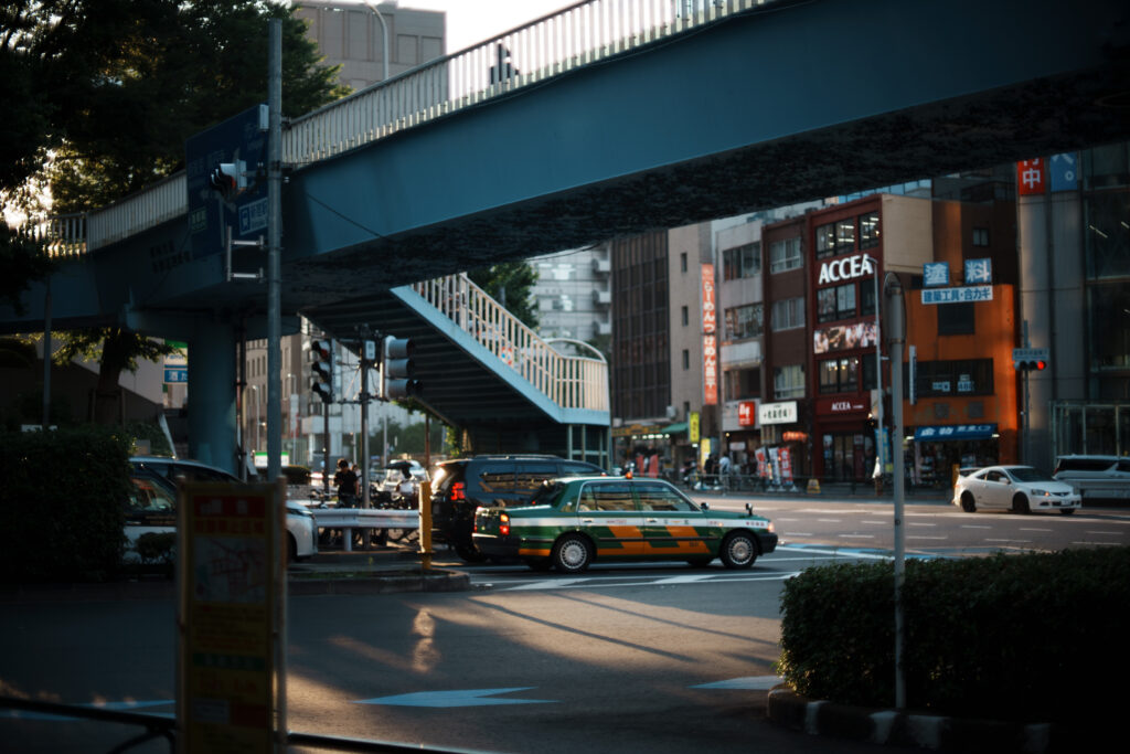 A taxi waiting at a traffic light